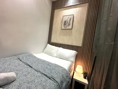 a small bedroom with a bed and a picture on the wall at Pathfinder Partition Room in Barsha Heights Tecom in Dubai