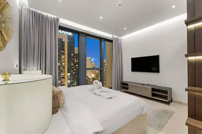 a bedroom with a large white bed and a large window at FIRST CLASS 4BR Spacious Luxury Retreat in Dubai
