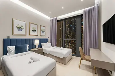 a hotel room with two beds and a television at FIRST CLASS 4BR Spacious Luxury Retreat in Dubai