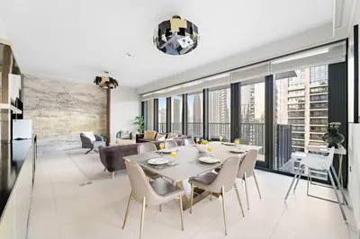 a dining room and living room with a table and chairs at FIRST CLASS 4BR Spacious Luxury Retreat in Dubai
