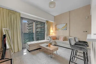 a living room with a couch and a table at Lavish Apartment in Dubai in Dubai