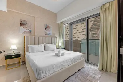 a bedroom with a large bed and a large window at Lavish Apartment in Dubai in Dubai