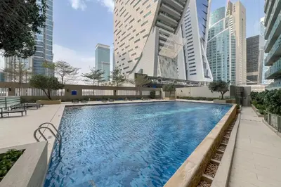 a swimming pool in a city with tall buildings at Lavish Apartment in Dubai in Dubai