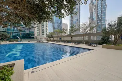 a swimming pool in a city with tall buildings at Lavish Apartment in Dubai in Dubai
