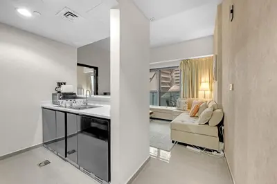 a kitchen and a living room with a couch at Lavish Apartment in Dubai in Dubai