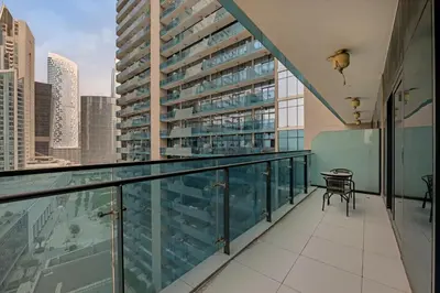 a balcony with a table and a view of a building at Lavish Apartment in Dubai in Dubai