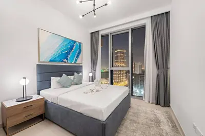 a bedroom with a large bed and a large window at FIRST CLASS Luxury 2BR in Creek Harbour Pool, Gym, Walk to Dining in Dubai