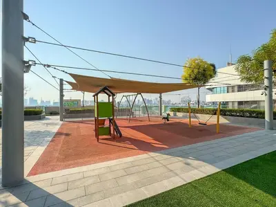 a playground with a canopy and a swing at FIRST CLASS Luxury 2BR in Creek Harbour Pool, Gym, Walk to Dining in Dubai