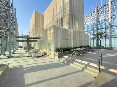 a building with some tables and chairs and some buildings at FIRST CLASS 1BR Urban Chic Oasis in Dubai