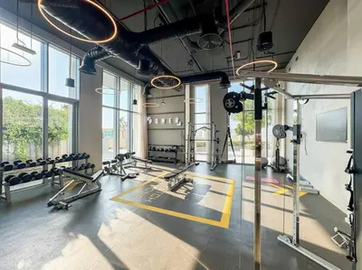 a gym with treadmills and machines in a room at FIRST CLASS 1BR Urban Chic Oasis in Dubai