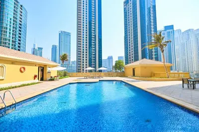 a pool in the middle of a city with tall buildings at Full Sea View - Spacious & Newly Renovated Studio in JBR in Dubai