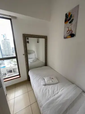 a room with a mirror and a bed in it at Four Stars Dubai Marina JBR in Dubai Marina
