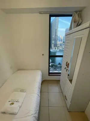 a small room with a bed and a window at Four Stars Dubai Marina JBR in Dubai Marina