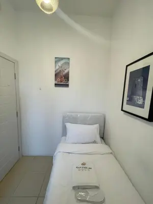 a bed in a room with a picture on the wall at Four Stars Dubai Marina JBR in Dubai Marina