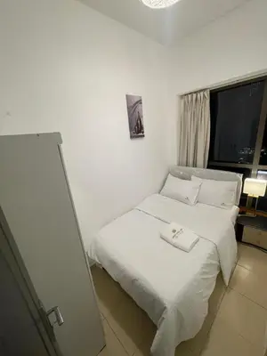 a hotel room with a bed with a towel on it at Four Stars Dubai Marina JBR in Dubai Marina