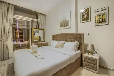 a bedroom with two beds and a window at 2BR - LUXE Serene Suite by Canal in Dubai