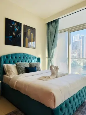 a bedroom with a large bed with a large window at 2BR - LUXE Serene Suite by Canal in Dubai