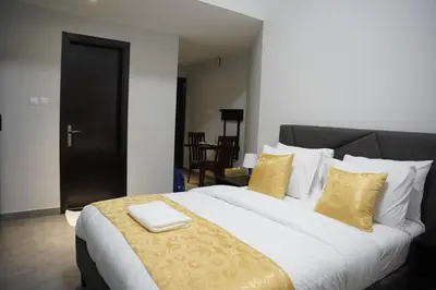 a bedroom with a large bed with yellow pillows at Ista Vacation Homes Rental LLC KARAMA in Dubai