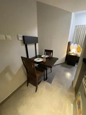 a dining room with a table and a chair at Ista Vacation Homes Rental LLC KARAMA in Dubai