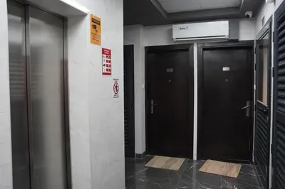 two elevators in a building with black doors at Ista Vacation Homes Rental LLC KARAMA in Dubai