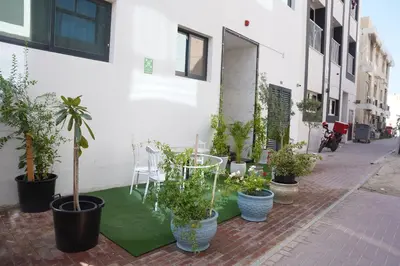 a group of potted plants on a sidewalk next to a building at Ista Vacation Homes Rental LLC KARAMA in Dubai