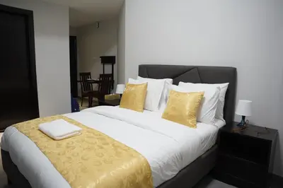 a bedroom with a large bed with yellow pillows at Ista Vacation Homes Rental LLC KARAMA in Dubai