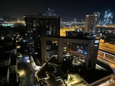 a view of a city at night with buildings at Nomad Partition Room in Barsha Heights 3 mins to ICM Metro in Dubai