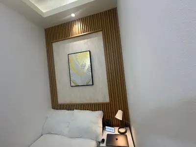 a room with a bed and a picture on the wall at Quiet Partition Room in Tecom Barsha Heights in Dubai