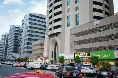 a busy city street with cars parked in front of a building at Horizon View Partition Room in Barsha Heights Near Metro in Dubai