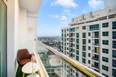 a balcony with a view of a building at Elite Waterfront 3BR Haven - Marina and Sea Views! in Dubai