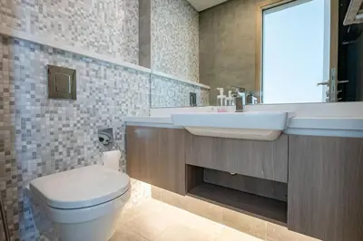 a bathroom with a white toilet and a sink at Top-Notch 3BR in Stella Maris Tower in Dubai Marina in Dubai