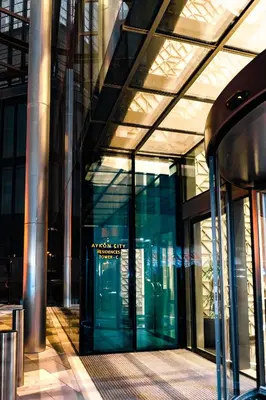 a large glass building with a revolving door at High rise studio near Dubai Mall in Dubai