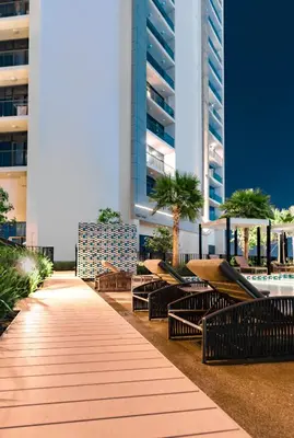 a walkway with tables and benches in front of buildings at High rise studio near Dubai Mall in Dubai