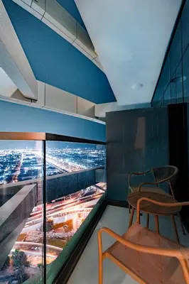 a chair in a room with a view of a city at High rise studio near Dubai Mall in Dubai