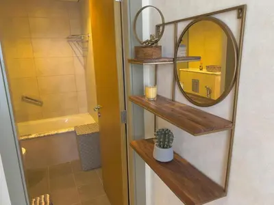 a bathroom with wooden shelves and a mirror at 2 bedroom in Downtown Dubai in Dubai
