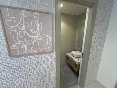 a bathroom with a painting on a wall with a sink at 2 bedroom in Downtown Dubai in Dubai