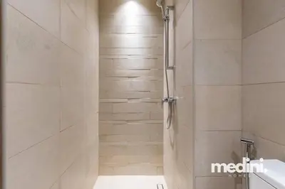 a shower with a glass door in a bathroom at Cozy Studio in Azizi Riviera - Dubai in Dubai