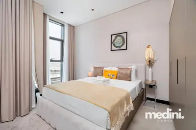 a bedroom with a large bed and a window at 15th Northside - Studio - Dubai in Dubai