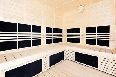 a sauna with black and white walls and benches at 15th Northside - Studio - Dubai in Dubai