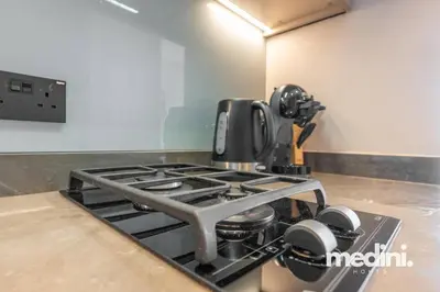 a kitchen stove with a coffee pot on it at 15th Northside - Studio - Dubai in Dubai