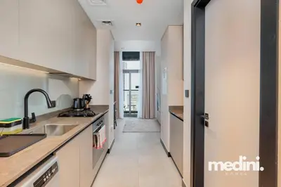 a kitchen with a sink and a counter at 15th Northside - Studio - Dubai in Dubai