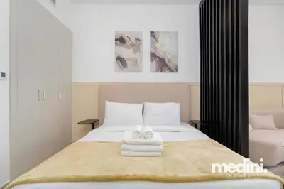 a bedroom with a bed with two towels on it at Studio in Bloom Height - JVC - Dubai in Dubai