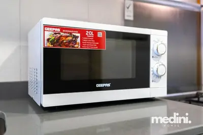a microwave sitting on a counter in a kitchen at Studio in Bloom Height - JVC - Dubai in Dubai