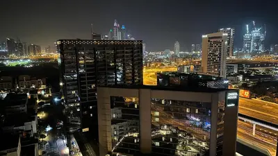a view of a city at night with buildings at Wanderlust Partiton Room in Tecom Near Internet City Metro in Dubai