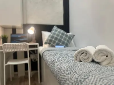 a bedroom with a bed with towels on it at Wanderlust Partiton Room in Tecom Near Internet City Metro in Dubai