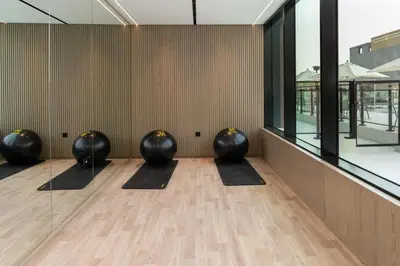 a row of black balls sitting in a room at Serene 1BR Haven with Pool View in Binghatti Corner! in Dubai