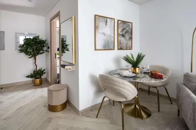 a living room with a table and a couch at Frank Porter - Empire Residences in Dubai