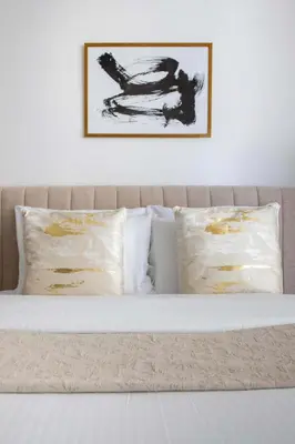 a bed with two pillows and a picture on the wall at Frank Porter - Empire Residences in Dubai