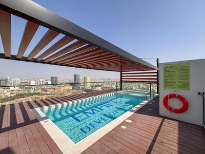 a swimming pool on the roof of a building at Frank Porter - Empire Residences in Dubai