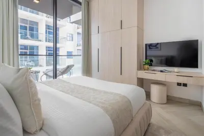 a bedroom with a large bed and a tv at Frank Porter - Empire Residences in Dubai